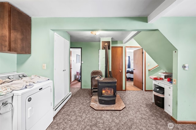 kitchen featuring a baseboard heating unit, a wood stove, washer and dryer, and carpet floors