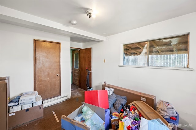 bedroom featuring baseboard heating and carpet