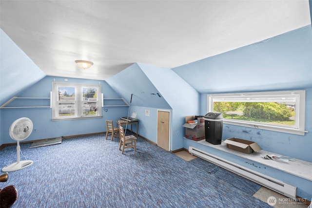 additional living space featuring baseboard heating, lofted ceiling, and carpet floors