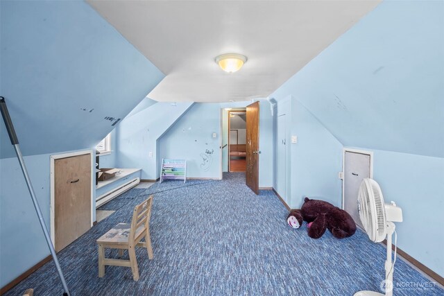additional living space with carpet floors and vaulted ceiling