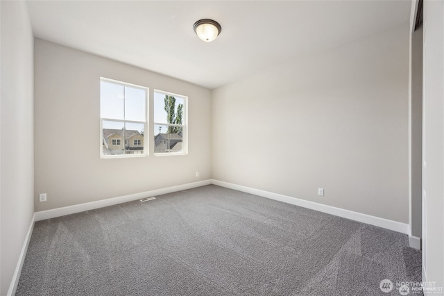 empty room featuring carpet floors, baseboards, and visible vents
