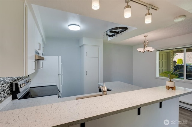 4502 216th St SW Unit A, Mountlake Terrace, WA 98043 - kitchen featuring stainless steel range with electric cooktop, a kitchen bar, under cabinet range hood, a sink, and hanging light fixtures