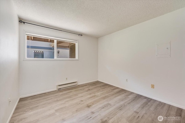 4502 216th St SW Unit A, Mountlake Terrace, WA 98043 - spare room featuring baseboards, a textured ceiling, wood finished floors, and baseboard heating