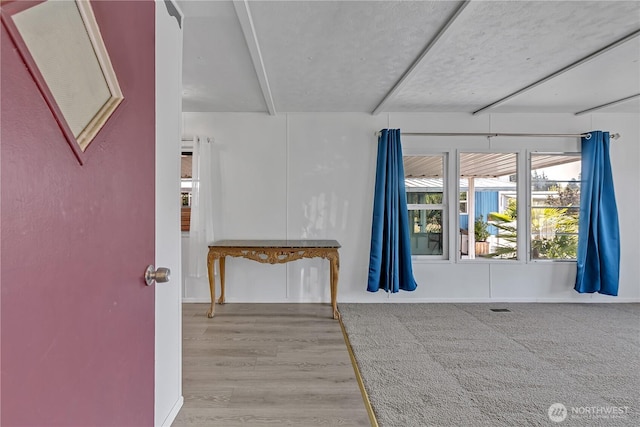 empty room featuring visible vents and wood finished floors