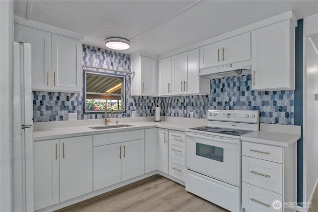 kitchen featuring under cabinet range hood, white cabinetry, white range with electric stovetop, and a sink