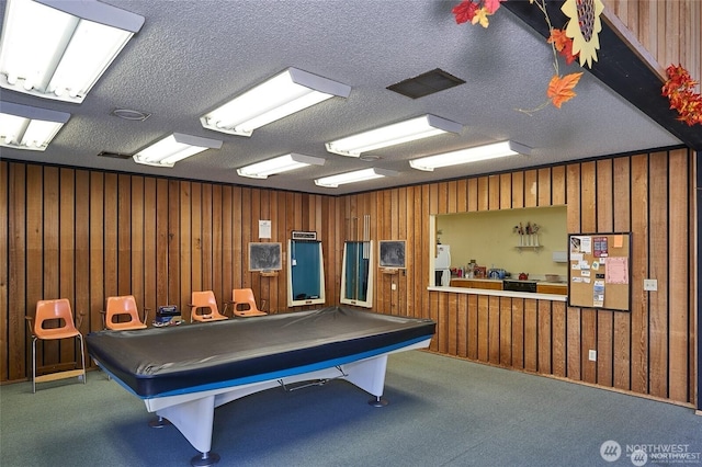 game room with billiards, carpet flooring, wood walls, and a textured ceiling