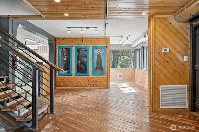 27510 Hwy 97, Cle Elum, WA 98922 - foyer entrance with hardwood / wood-style flooring, track lighting, wood walls, and visible vents