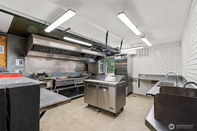 27510 Hwy 97, Cle Elum, WA 98922 - kitchen with stainless steel counters, stainless steel refrigerator, and range hood