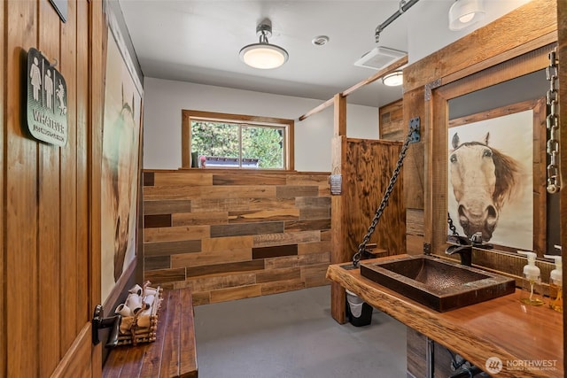 27510 Hwy 97, Cle Elum, WA 98922 - mudroom with a wainscoted wall, wood walls, finished concrete flooring, and a sink