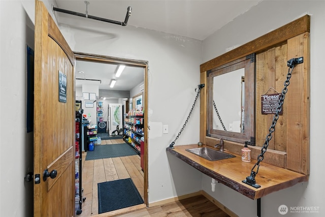 27510 Hwy 97, Cle Elum, WA 98922 - hallway featuring light wood finished floors, baseboards, and a sink