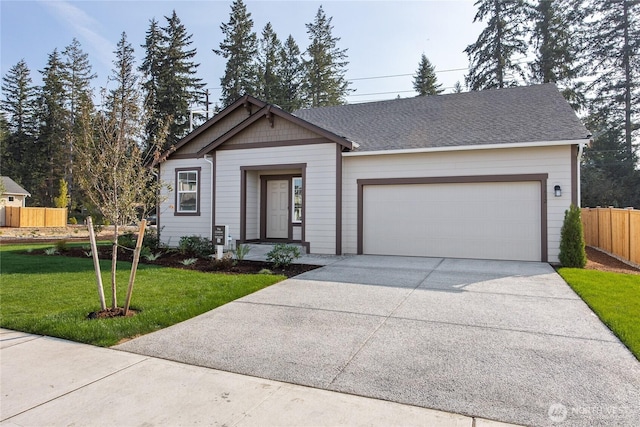 ranch-style home with fence, driveway, roof with shingles, a front lawn, and an attached garage