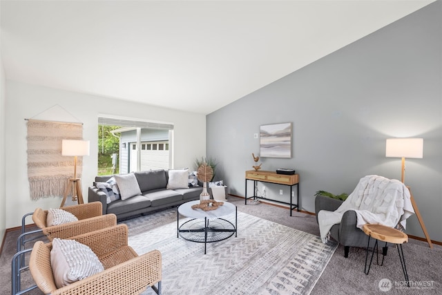 carpeted living area with baseboards and lofted ceiling