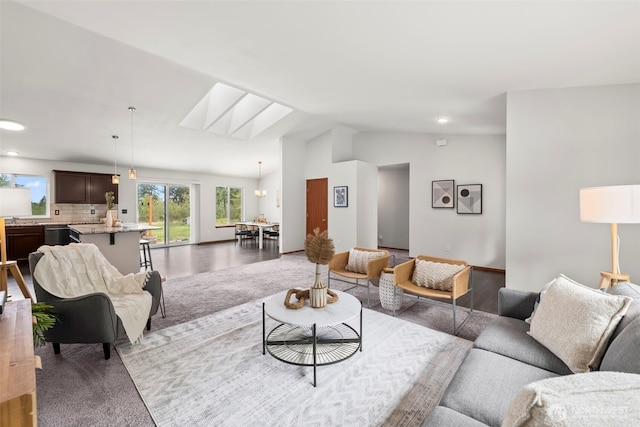 living area with recessed lighting and vaulted ceiling with skylight