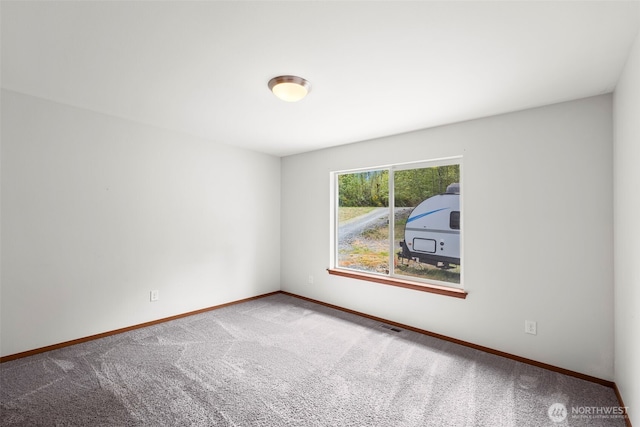 unfurnished room featuring carpet floors, baseboards, and visible vents