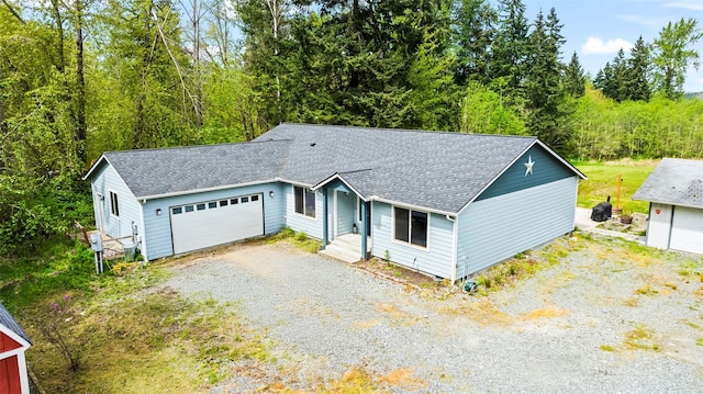 ranch-style house with roof with shingles and gravel driveway