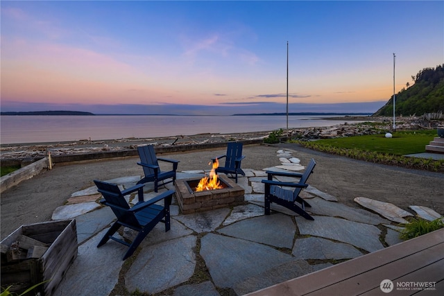 view of patio featuring a water view and an outdoor fire pit