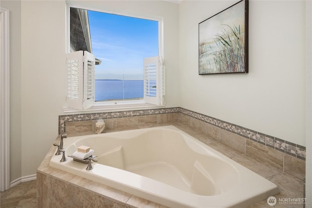 full bath featuring a water view and a bath