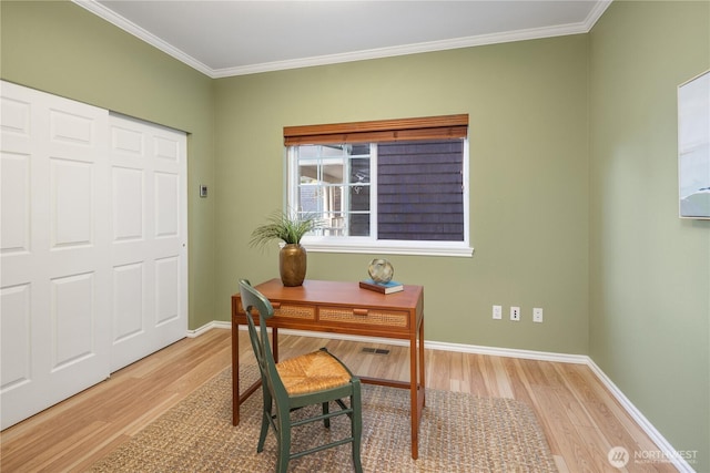 office space with baseboards, ornamental molding, and wood finished floors