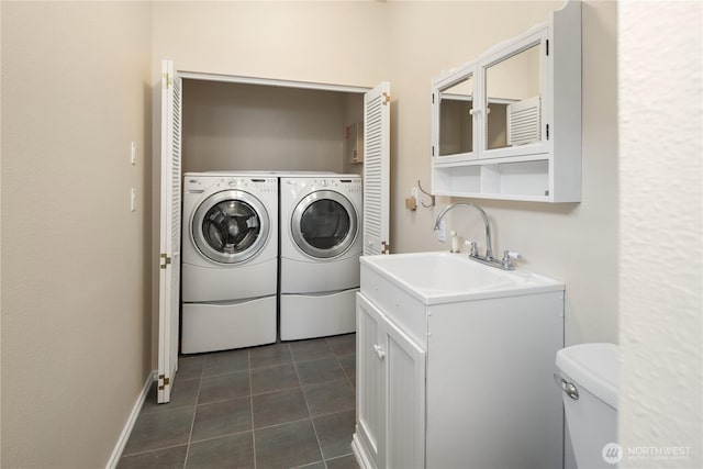 washroom featuring laundry area, a sink, independent washer and dryer, and dark tile patterned flooring