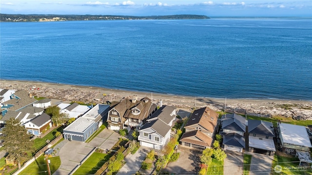 aerial view featuring a residential view, a view of the beach, and a water view