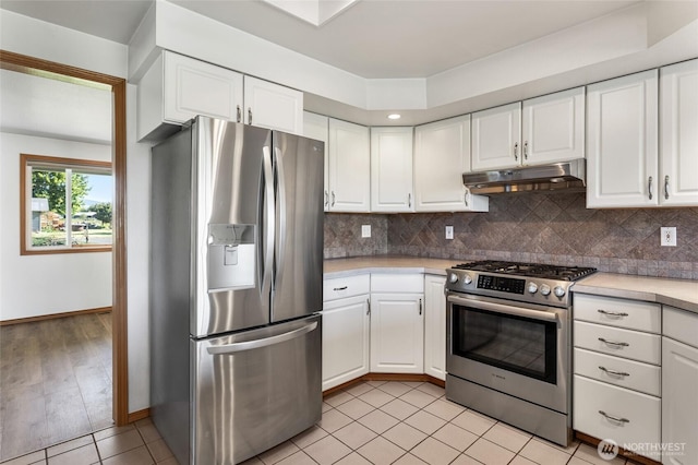 2710 Willowdale Rd, Ellensburg, WA 98926 - kitchen with appliances with stainless steel finishes, under cabinet range hood, light countertops, and white cabinets