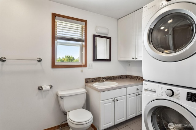 2710 Willowdale Rd, Ellensburg, WA 98926 - washroom with stacked washer and clothes dryer and tile patterned flooring