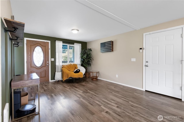 foyer featuring baseboards and wood finished floors