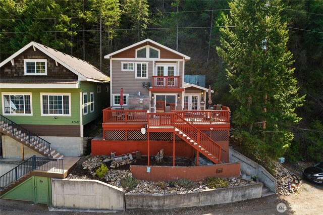 view of front facade featuring stairs, a balcony, and a deck