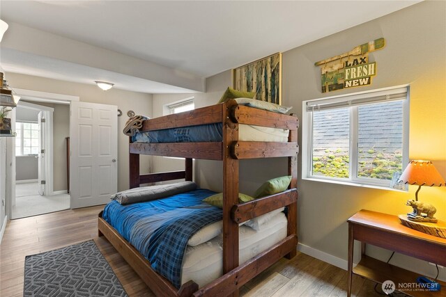 bedroom featuring baseboards and wood finished floors