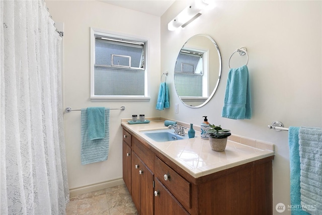 bathroom with vanity and baseboards