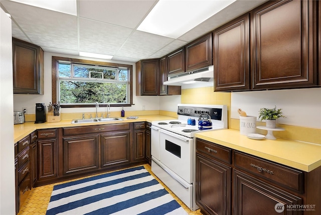 kitchen with white electric range oven, under cabinet range hood, a sink, and light countertops