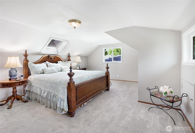 bedroom featuring light carpet, lofted ceiling, and baseboards