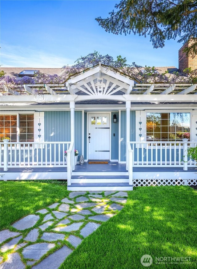 view of front of property featuring a porch, a front lawn, and board and batten siding