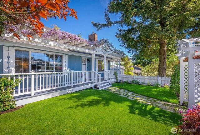 back of property featuring a pergola, a chimney, and a porch