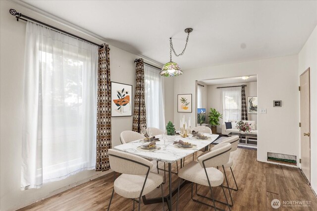 dining area with wood finished floors