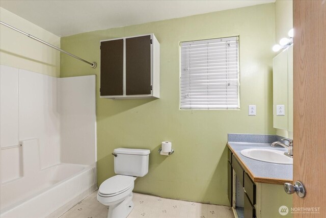 bathroom featuring vanity, bathing tub / shower combination, and toilet