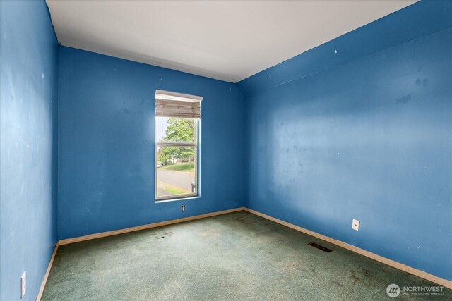 carpeted spare room with baseboards and visible vents