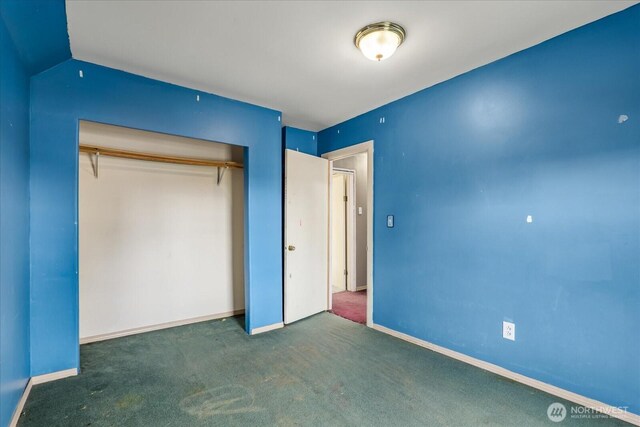 unfurnished bedroom with a closet, baseboards, and carpet floors