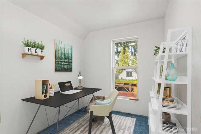 office space with vaulted ceiling and carpet