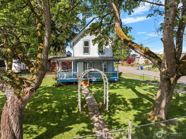 view of front of home featuring a porch, fence private yard, and a front yard