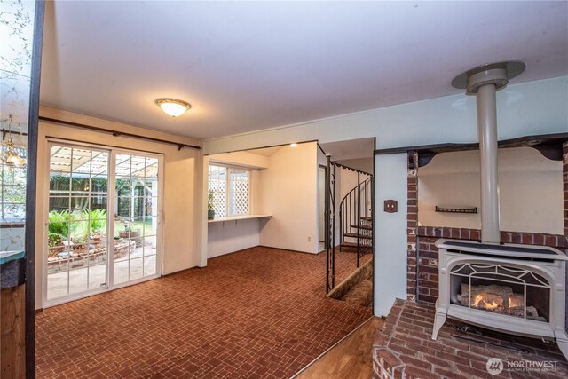 2916 SW 329th St, Federal Way, WA 98023 - interior space featuring a wood stove, brick flooring, and stairs