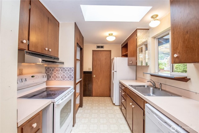 2916 SW 329th St, Federal Way, WA 98023 - kitchen featuring white appliances, under cabinet range hood, a sink, and a skylight