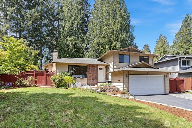 split level home featuring an attached garage, a chimney, driveway, and a shingled roof