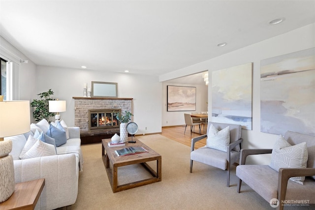 living area featuring recessed lighting, a brick fireplace, and wood finished floors