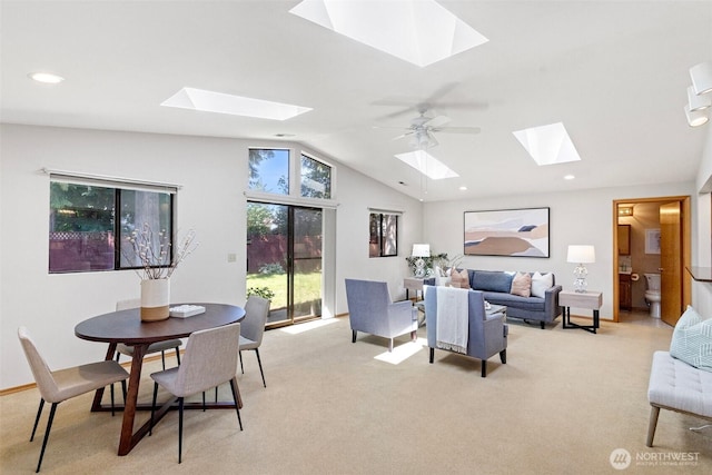 living room featuring a skylight, light carpet, lofted ceiling, recessed lighting, and baseboards
