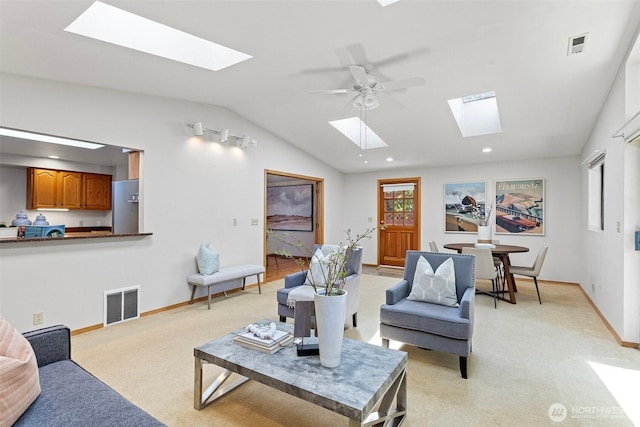 living room featuring a skylight, light carpet, lofted ceiling, baseboards, and recessed lighting