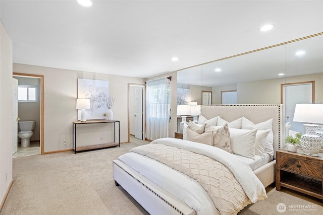 carpeted bedroom with recessed lighting, baseboards, and ensuite bathroom