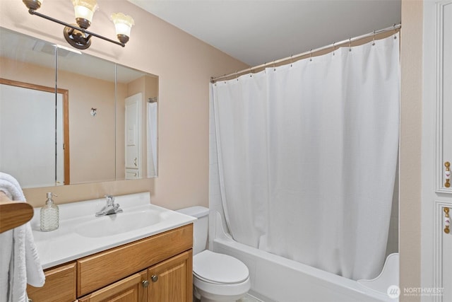full bathroom with shower / bath combo, vanity, and toilet