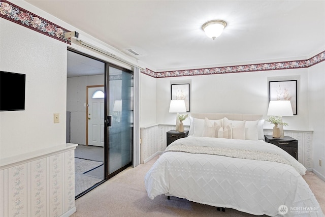 bedroom with light colored carpet and a closet