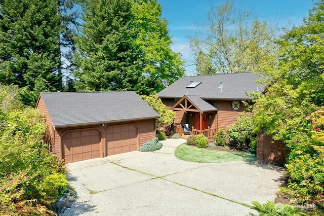rustic home with a detached garage, an outdoor structure, and roof with shingles